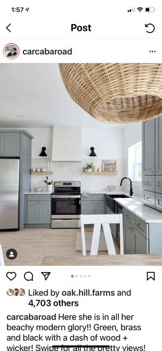 an instagramted photo of a kitchen with gray cabinets and white countertops, including a wicker basket hanging from the ceiling