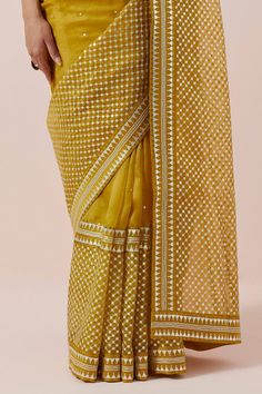 Mustard yellow saree in silk organza base with silver and gold aari, sequin and zari work. Paired with a halter neck blouse and petticoat. - Aza Fashions Mustard Yellow Saree, Halter Neck Blouse, Halter Neck Blouses, Aari Blouse, Yellow Saree, Zari Work, Yellow Blouse, Silk Organza, Sarees Online