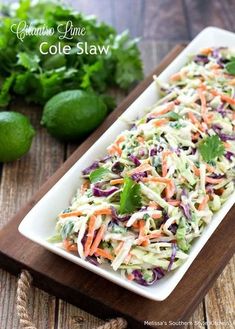 coleslaw on a plate with limes and cilantro in the background