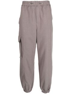 a grey sweat pants with pockets on the front and side, one pocketed at the bottom