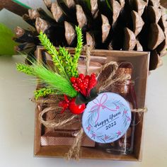 a christmas gift box with pine cones and berries