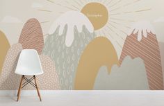 a white chair sitting in front of a wall mural with mountains and sunbursts