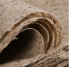 a close up view of some kind of carpet with the end rolled down to show it's texture