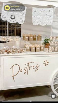 an ice cream cart is decorated with white doily and brown lettering that says posites