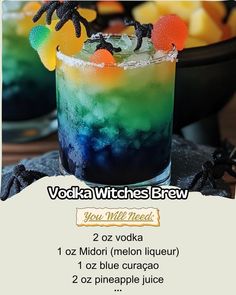 a colorful drink with halloween decorations on the rim