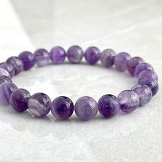 > 6mm or 8mm Chevron Amethyst > Stretchy cord; simply slide bracelet on and off wrist > Re-usable canvas pouch To ensure the perfect fit, please use the bracelet sizing instructions found in the photo gallery. Amethyst Beaded Bracelet, Shambala Bracelet, Amethyst Bracelet Beads, Beaded Braclets, Stretchy Beaded Bracelet, Buddha Bracelets, Slide Bracelet, Chevron Amethyst, Energy Bracelets