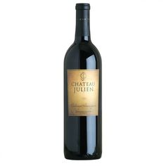 a bottle of chateau julienn red wine on a white background with the label in gold