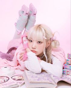 a woman laying on top of a pile of books