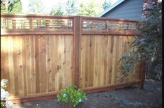 a wooden fence in front of a house