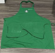 the apron is green and has a starbucks logo on it