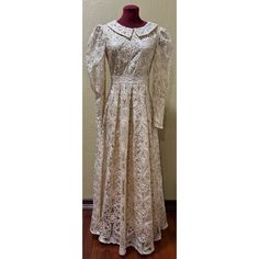 This Cream And Gold Color Embroidered Maxi Dress Has Ten Gold Buttons On Each Sleeve, A Band Around The Waist, And A Back Zipper Closure. Made Of Imported Material And Recommended Care Is Dry Clean Only. The Dress Is Brand New, With Tag, And Has Never Been Worn. Formal Maxi Dress With Lace Work, Classic Spring Dresses For Church, Vintage Fitted Dresses For Church, Elegant Church Dress With Lace Trim, Elegant Lace Trim Dress For Church, Formal Cream Dress With Lace Collar, Elegant Cream Dresses For Church, Cream Lace Trim Dress For Church, Classic Fitted Dress With Lace Work