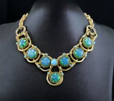 "This fabulous RARE vintage necklace is made with green blue art glass \"cat eye\" cabochons on a linked chain, accented with small turquoise cabochon rhinestones. The large art glass stones are all dog tooth prong set. This has the typical early Dior \"S\" hook fastener, and chunky link chain typical to Henkel & Grosse or Francis Winter. Many of the early pieces came only with a paper hangtag, which is long gone. This necklace is over-the-top GORGEOUS Dazzling if I may say so! The setting is heavy gold plated and does not show any wear. This is a stunning necklace in excellent vintage condition. Spectacular piece! Marked: None Measurements:  20\" maximum wearable length Condition:  Excellent vintage condition. No missing or damaged stones. No visible wear to the gold finish. I try to find Green Cabochon Jewelry For Evening, Luxury Vintage Jewelry With Large Stone, Luxury Antique Gemstone Necklaces, Gripoix Jewelry, Blue Crystal Necklace Costume Jewelry, Blue Crystal Costume Jewelry Necklace, Luxury Vintage Rhinestone Necklaces, Vintage Necklaces Blue Rhinestones, Blue Dior