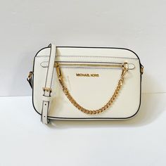 New With Tag Michael Kors Jet Set Item East West Chain Crossbody Shoulder Bag Saffiano Leather Optic White Gold Toned Hardware 100% Authentic Retail: $398.00 Plus Tax **The Pictures Look Larger Than The Bag** ***The Model Is 5'11" And Size 2*** ***Please See The Measurement For The Size*** Zip Top Closure Michael Kors Logo At Front 1 Zipper Pocket At Front Exterior Custom Fabric Lining 2 Slip-In Pockets 10" (L) X 6"(H) X 2.5"(D) Strap: 20"-23" Very Clean, Smoke-Free And Pet-Free Environment. Michael Kors Logo, Convertible Crossbody Bag, Large Crossbody Bags, Brown Crossbody Bag, Michael Kors Crossbody Bag, Brown Shoulder Bag, Black Leather Crossbody Bag, Crossbody Wallet, Handbag Straps