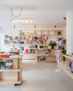 a room filled with lots of books and furniture