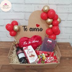 a gift box filled with red balloons, chocolates and confection items for someone's special occasion