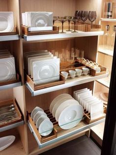 the shelves are filled with dishes and plates