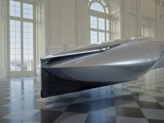 a futuristic car is parked in an empty room