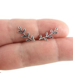 Tiny Leaf Earrings in Sterling Silver, Branch Stud Earrings, Leaf Earrings, Dainty Earrings, Sterling Silver Earrings, Gift for HerA sweet pair of tiny Leaf Branch Earrings in Sterling Silver.Earrings are made of 925 silver and measure 6x15mmThese earrings are great for those with sensitive earsMix and match with my other stud earringsIncludes sterling silver ear backs.This listing is for one pair (2 pieces).Your earrings will ship in a gift box. Nature Inspired Silver Jewellery, Cute Sterling Silver Earrings, Sterling Silver Earrings Aesthetic, Silver Earring Studs, Simple Cute Earrings, Simple Earrings Silver, Unique Stud Earrings, Simple Silver Earrings, Celtic Knot Earrings