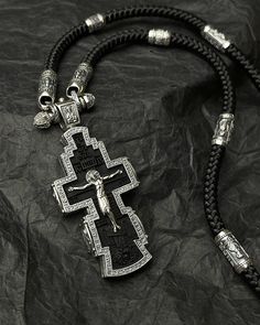 This elegant Orthodox cross pendant features a 925 sterling silver design paired with rich ebony wood, making it a striking Christian cross. Inscribed with "Lord, have mercy on me," it embodies a deep spiritual sentiment. The pendant hangs gracefully from a silk lanyard, adding a touch of sophistication to this meaningful religious gift. Perfect for those seeking a unique and heartfelt expression of faith. FEATURES: -High-Quality 925 Sterling Silver: Crafted from genuine 925 sterling silver, ens Black Engraved Pendant Cross Necklace, Black Engraved Cross Necklace Gift, Engraved Black Cross Necklace As Gift, Engraved Black Cross Necklace For Gift, Gift Black Engraved Cross Necklace, Have Mercy On Me, Lord Have Mercy, On Me, Lion Tattoo Design