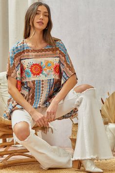 Floral Poncho Top This Woven Poncho Top features delicate floral embroidery across the front. The neckline is round and the fit is flowy and loose, making it a comfortable and stylish choice. A S/M fits a bust of 34-36" (a size 4-8) and a M/L fits a bust of 35-38" (a size 6-10). Brand: Savanna Jane Spring Bohemian Crew Neck Blouse, Bohemian Blouse With Floral Print And Relaxed Fit, Floral Print Crew Neck Blouse For Beach, Floral Print Crew Neck Blouse For Vacation, Vacation Floral Print Crew Neck Blouse, Bohemian Flowy Tunic With Batwing Sleeves, Vacation Blouse With Floral Print And Crew Neck, Casual Embroidered Flowy Blouse, Bohemian Flowy Embroidered Top With Floral Design