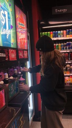 a woman standing in front of a vending machine