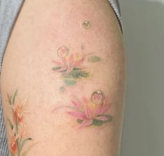 a close up of a person's arm with flowers on it