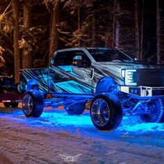 a truck is parked in the snow with lights on it's wheels and tires