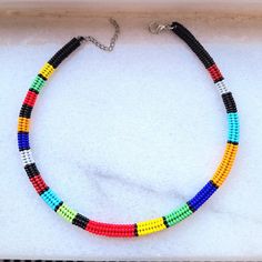 This handmade beaded necklace is made from the highest quality glass seed beads, carefully woven by hand! The vibrantly colored choker necklace fits perfectly on your neck thanks to its stainless steel clip and extension chain! Lenght 15 inches (40 cm) The necklace that you can use in all seasons, compatible with all your clothes, is the ideal handmade gift jewelry for you and your loved ones. Guaranteed to get all the compliments! You can click the link for other handmade jewelry and accessories! https://yasminjewelrygifts.etsy.com Your orders will be shipped the next day. Thank you for supporting and shopping with my small business :) Multicolor Beaded Choker With Round Beads, Multicolor Heishi Beaded Necklaces With Large Beads, Multicolor Beaded Heishi Beads Choker, Multicolor Beaded Choker With Heishi Beads, Adjustable Multicolor Beaded Necklaces With Black Beads, Artisan Multicolor Heishi Beads Necklace, Traditional Heishi Beaded Necklaces, African Beads Necklace, African Gifts