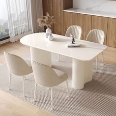 a white table with four chairs and a vase on the top, in front of a window