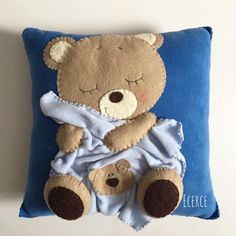 a blue pillow with a teddy bear on it