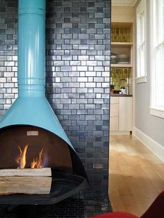 a blue fireplace in the middle of a living room