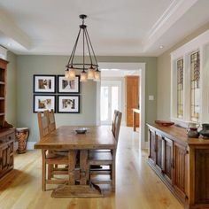 the dining room table is surrounded by wooden chairs