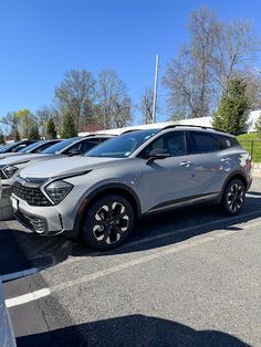 a row of cars parked in a parking lot next to each other on a sunny day