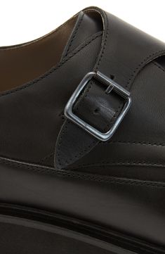 Neat stitching enhances the clean lines of a smooth leather monk-strap shoe grounded by a durable rubber sole. Leather upper and lining/rubber sole Made in Portugal Black Calf Leather Monk Strap Shoes With Leather Footbed, Black Leather Monk Strap Shoes With Brogue Detailing, Classic Black Monk Strap Shoes With Brogue Detailing, Monk Strap Shoes With Buckle Closure And Round Toe, Black Leather Monk Strap Slip-on Shoes, Black Monk Strap Shoes With Brogue Detailing For Business, Black Leather Monk Strap Shoes With Leather Footbed, Black Buckle Closure Loafers For Business, Calf Leather Monk Strap Shoes With Tang Buckle