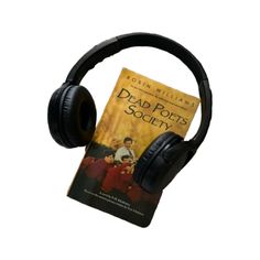 a book and headphones sitting next to each other