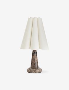 a table lamp with a white shade on it's base and a marble base