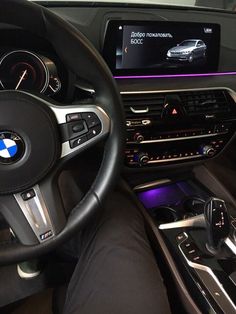 the interior of a bmw car with an electronic display and steering wheel, dashboard lights, and dash board