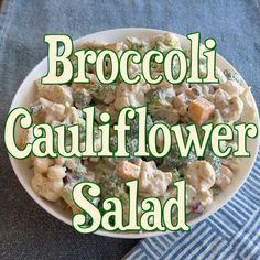 broccoli cauliflower salad in a bowl with the words broccoli cauliflower salad