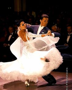 a man and woman are dancing in front of an audience