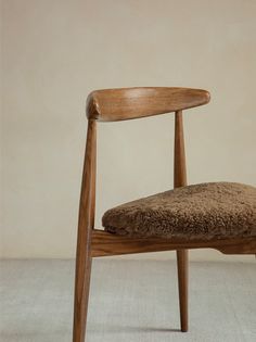 a wooden chair with a brown cushion on it