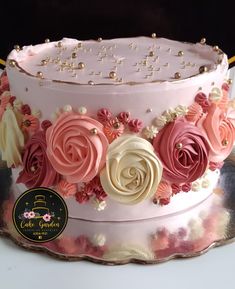 a cake decorated with pink and white flowers