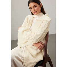 Off-white knit (100% Acrylic). Sweater. Long sleeves. V-neck. Front zipper closure. 7.5" from shoulder to hemline. Imported. Cream Cable Knit Long Sleeve Outerwear, Oversized Cable Knit Long Sleeve Outerwear, Cream Long Sleeve Cable Knit Cardigan, Cream Chunky Knit V-neck Sweater, Cream Long Sleeve Cable Knit Top, Chunky Cable Knit Sweater, Chunky Cable Knit, Acrylic Sweater, Cable Knit Sweater