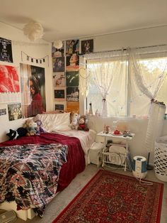 a bed room with a neatly made bed and lots of pictures on the wall