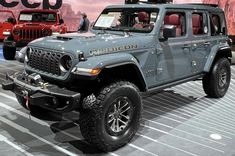 a jeep is on display at an auto show