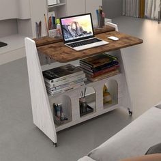 an open laptop computer sitting on top of a wooden desk next to a white couch