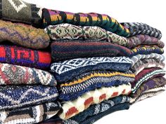 a pile of multicolored sweaters sitting on top of each other