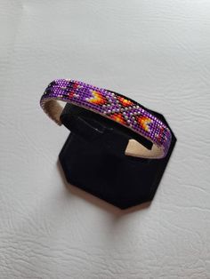 "I use size 15 seed beads. The length is 6\" and width is 3/8\". Product is an adjustable cuff bracelet with a pigskin covering." Southwestern Style Adjustable Cuff Bracelet With Round Beads, Adjustable Beaded Cuff Bracelet Bangle, Southwestern Adjustable Bracelet With Large Beads, Adjustable Southwestern Beaded Bracelet With Large Beads, Southwestern Adjustable Beaded Bracelet With Large Beads, Adjustable Beaded Wristlet For Festival, Traditional Adjustable Cuff Bracelet With Colorful Beads, Traditional Adjustable Purple Bracelets, Adjustable Cuff Bracelet With Colorful Beads