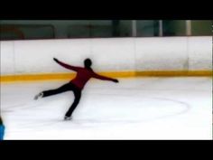 a man skating on an ice rink with his arms out and hands in the air