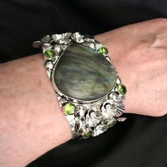 Stunning 925 Sterling Silver Cuff Bracelet 6.5 Inches N Length 60 Carats Of Labradorite Stones 12 Carats Of Peridot Stones This Will Be A Nice Addition To Your Jewelry Collection. Thanks For Dropping In An Checking My Closet Out. God Has Blessed Me With Such Wonderful People In My Life. May Gods Light Shine Upon All Of You. Hugs. Elegant Silver Multi-stone Cuff Bracelet, Silver Fusion Cuff Bracelet With Oyster Design, Silver Multi-stone Fusion Bracelets, Unique Sterling Silver Bangle With Gemstone, Unique Sterling Silver Gemstone Bangle, Silver Fusion Bracelets With Multi-stone, Fusion Style Multi-stone Silver Bracelets, Silver Fusion Style Multi-stone Bracelets, Adjustable Multi-stone Sterling Silver Bracelet