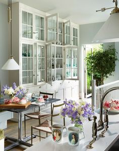 a kitchen filled with lots of furniture and flowers